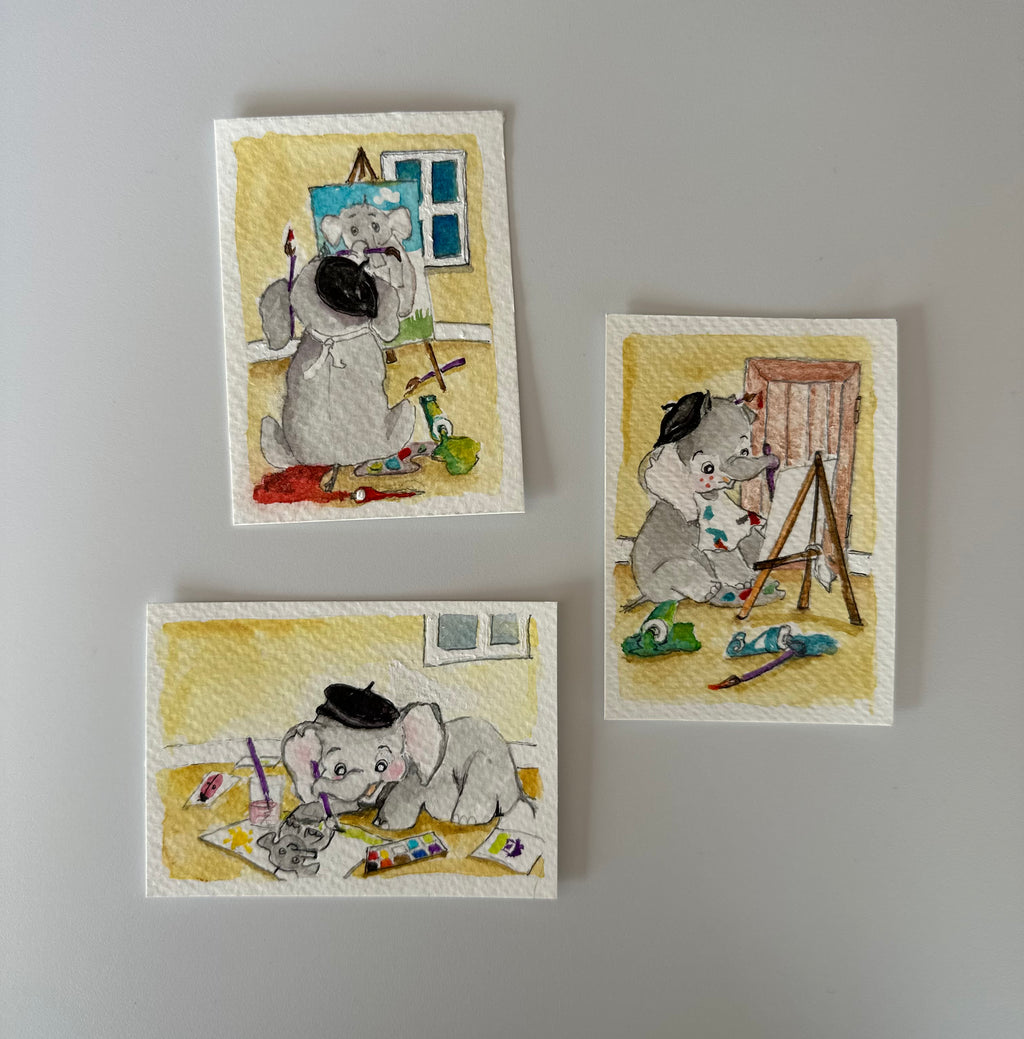 Three small watercolor art prints featuring cute painted elephants painting at a desk, arranged on a light gray background.